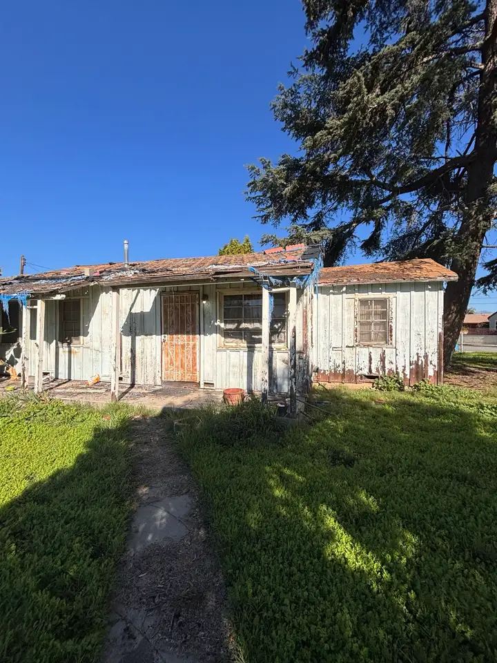 The front walk up to the house, the roof sagging over the porch